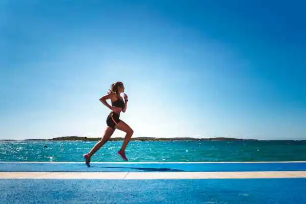 Woman running showing strong leg muscle Wiltshire
